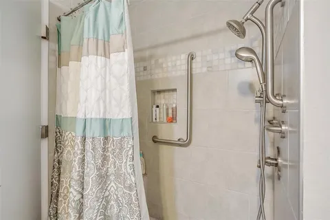 a bathroom with a shower and a tub