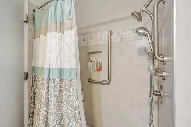 a bathroom with a shower and a tub