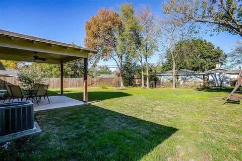 a view of a backyard with sitting area