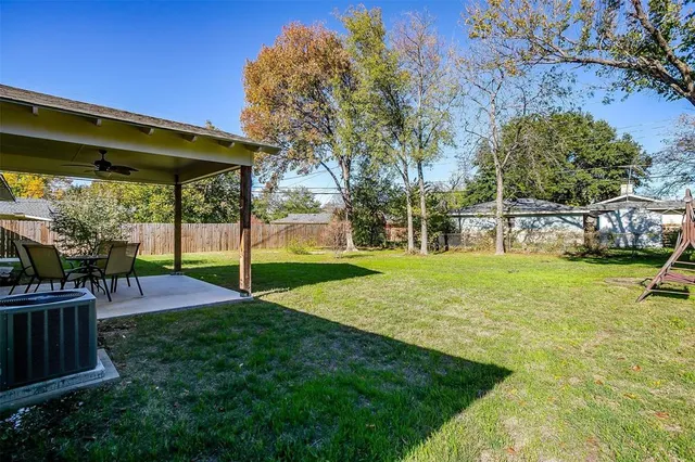 a view of a backyard with sitting area