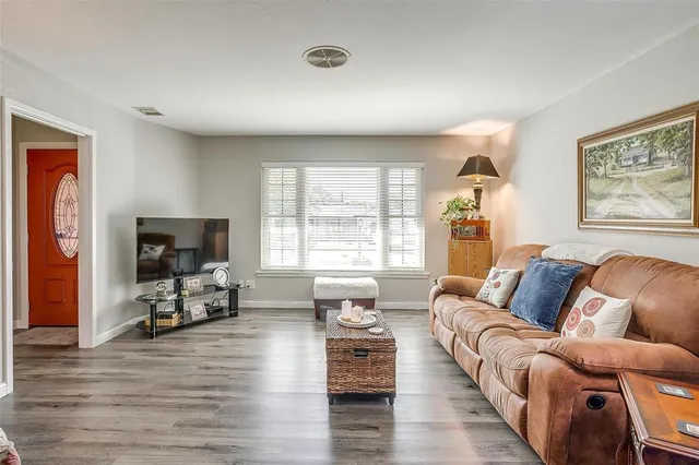 a living room with furniture or couch and a wooden floor