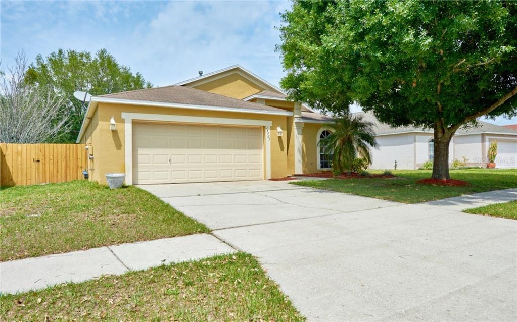 24905 Laurel Ridge Drive Lutz, FL 33559 - Photo 1 of 1 a front view of a house with a yard and garage