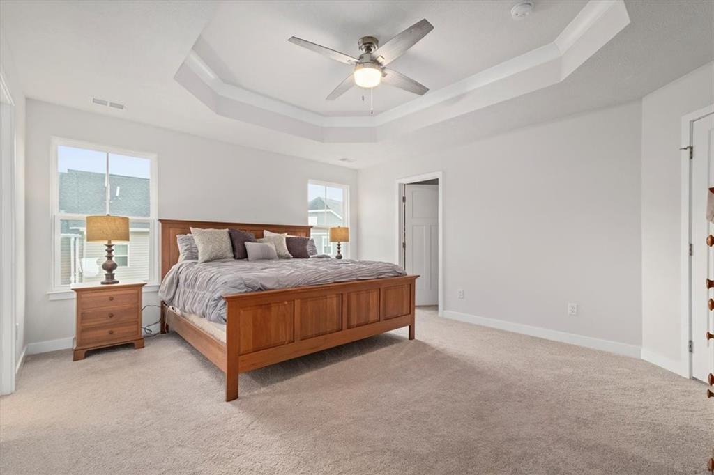 232 Cranesbill Drive Mars, PA 16046 - Photo 18 of 25 a bedroom with a large bed and a chandelier