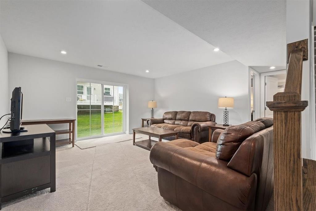 232 Cranesbill Drive Mars, PA 16046 - Photo 21 of 25 a living room with furniture a floor to ceiling window and a flat screen tv