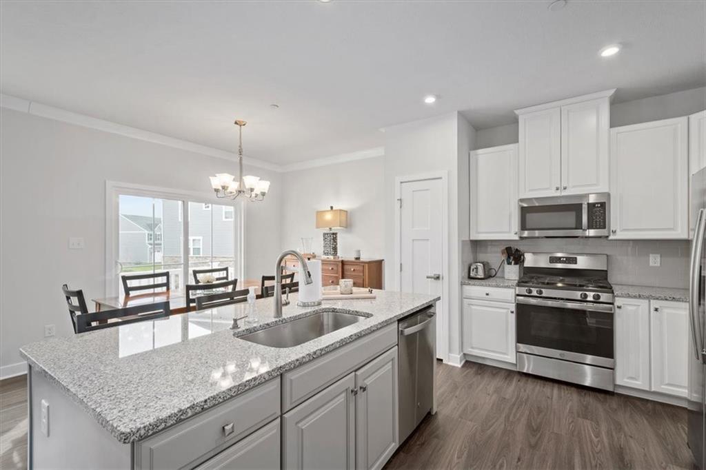 232 Cranesbill Drive Mars, PA 16046 - Photo 7 of 25 a kitchen with stainless steel appliances granite countertop a sink a stove and microwave