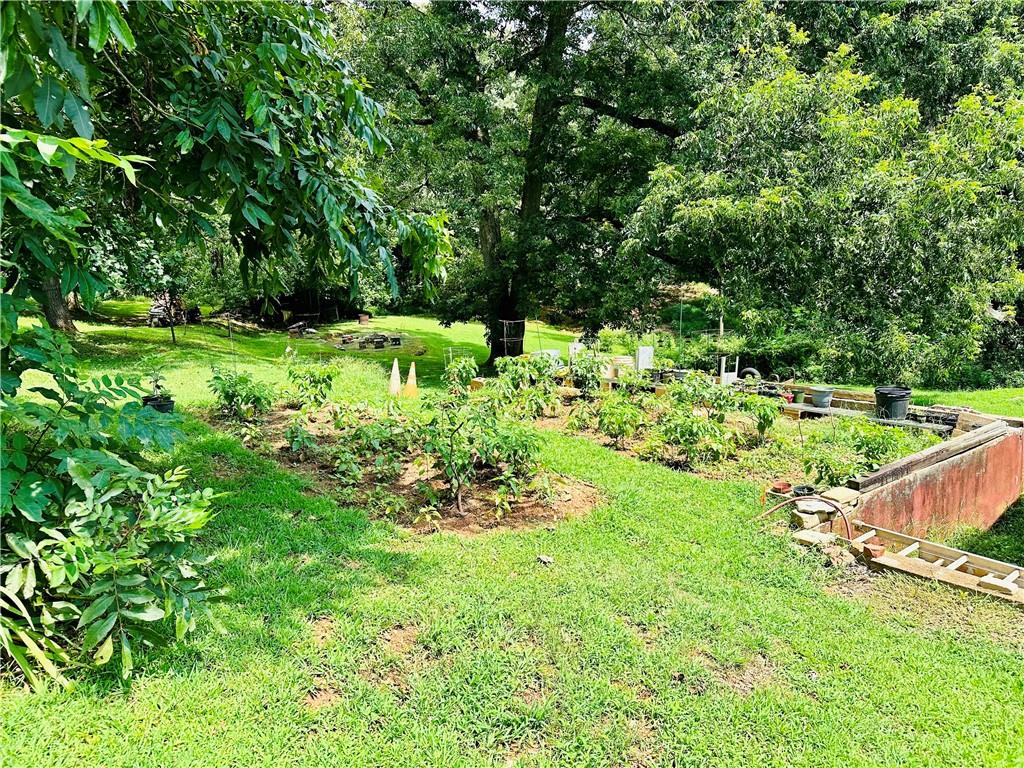 2582 White Sulphur Road Gainesville, GA 30501 - Photo 3 of 7 a view of a garden with a bench