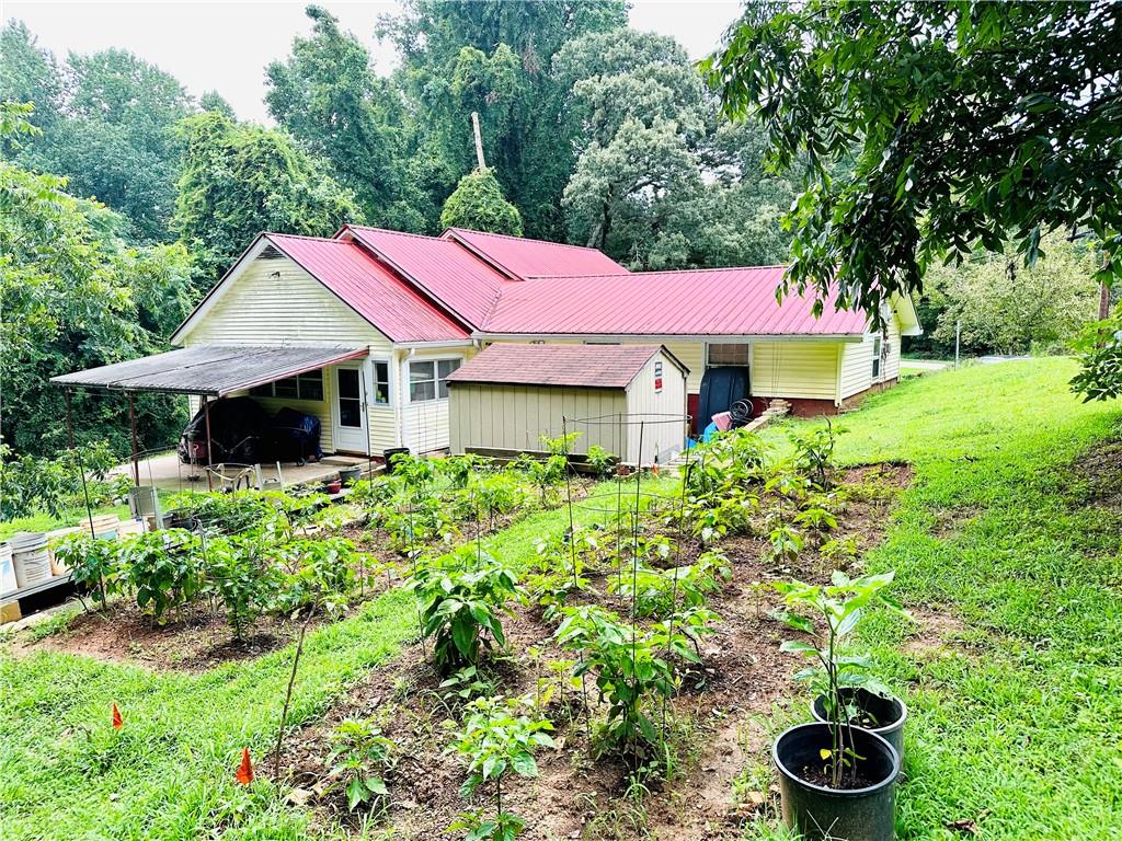 2582 White Sulphur Road Gainesville, GA 30501 - Photo 7 of 7 a front view of a house with a yard and fountain