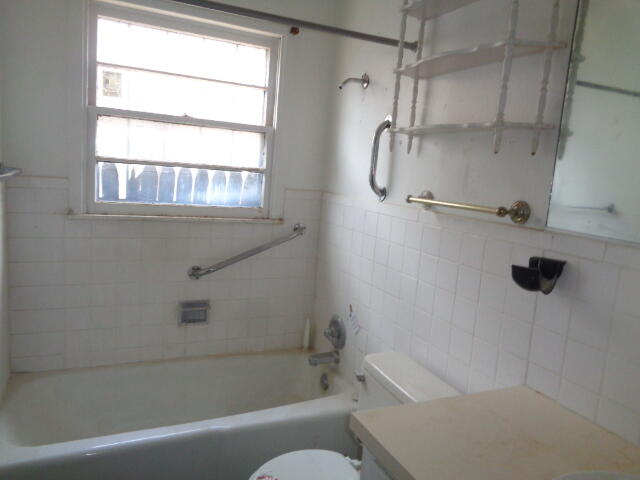 1329 49th Street Lubbock, TX 79412 - Photo 8 of 13 a bathroom with a bath tub with a shower