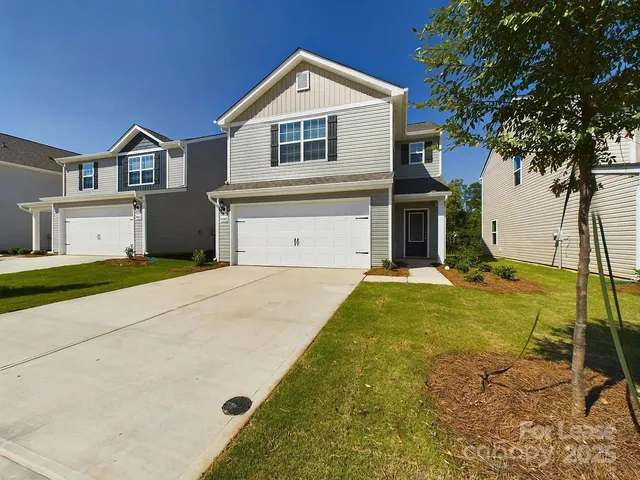 a front view of a house with yard