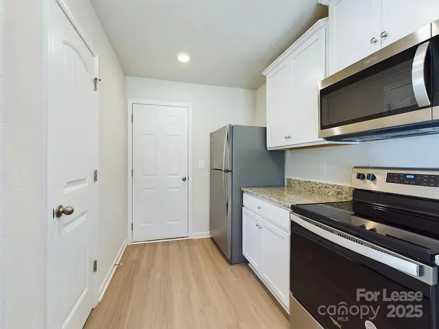 a kitchen with a refrigerator stove and microwave