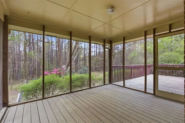 a view of porch with wooden floor and floor to ceiling window