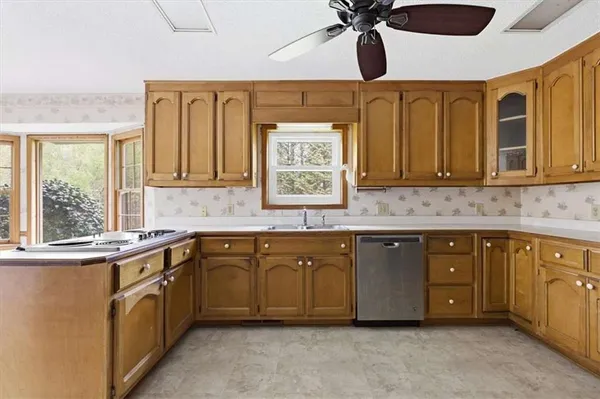 a kitchen with stainless steel appliances granite countertop a sink and cabinets