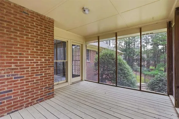a view of a room with wooden floor and large windows