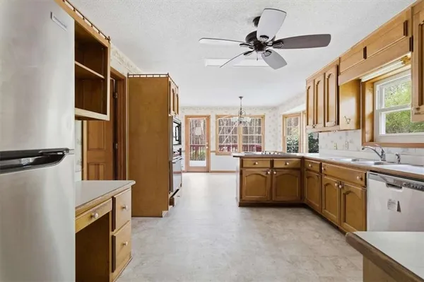 a kitchen with a refrigerator a sink and cabinets