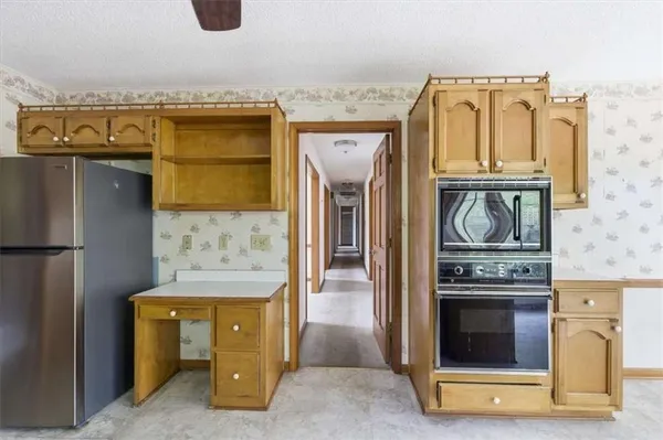 a kitchen with a stove and a refrigerator