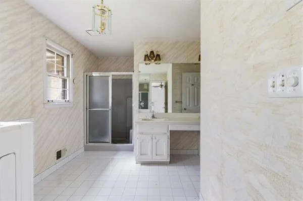 a view of a hallway with entryway cabinet and front door