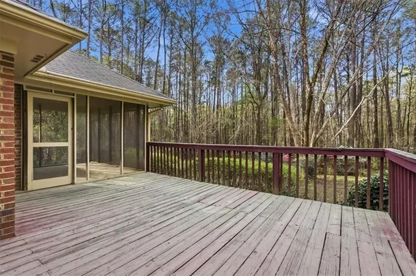 a balcony with wooden floor and fence