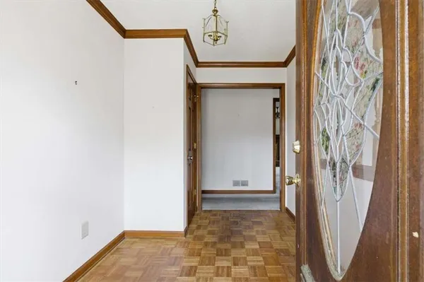 a view of a hallway with wooden walls and entryway
