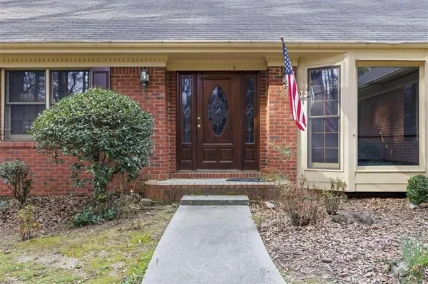 a front view of a house with garden
