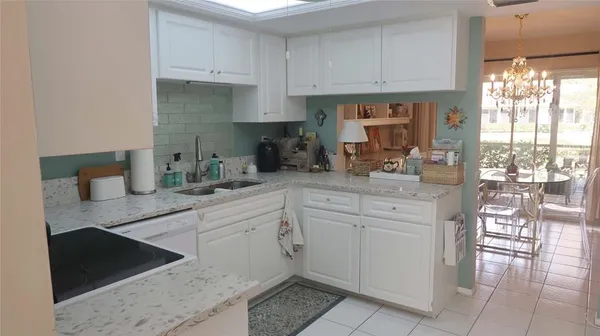 a kitchen with cabinets and window