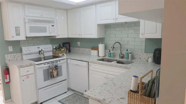 a kitchen with stainless steel appliances granite countertop a sink and a stove