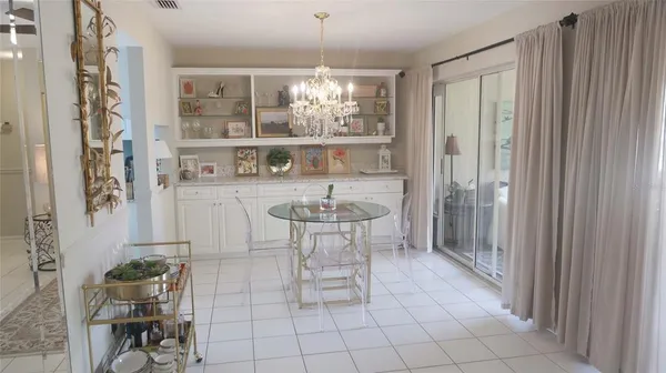 a view of a room with furniture and a chandelier
