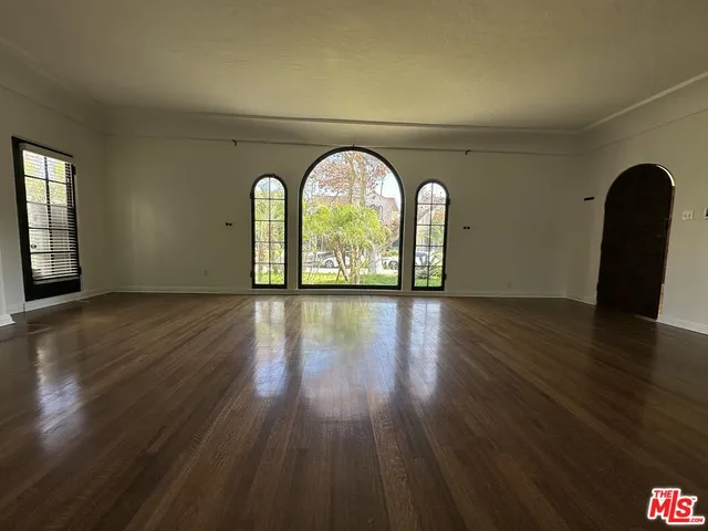 a view of a room with wooden floor