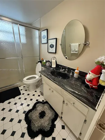a bathroom with a sink a toilet and a mirror