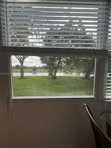 a view of a floor to ceiling window and a yard