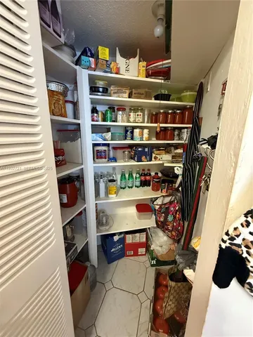 a table with wine bottles and chairs