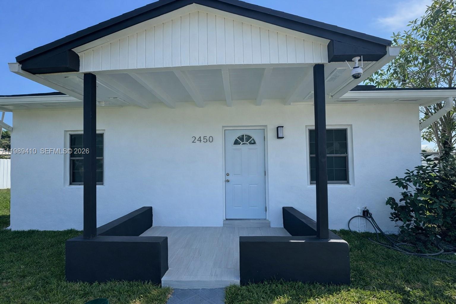 2450 Northwest 157th St Road Miami Gardens, FL 33054 - Photo 2 of 24 a front view of a house with garden