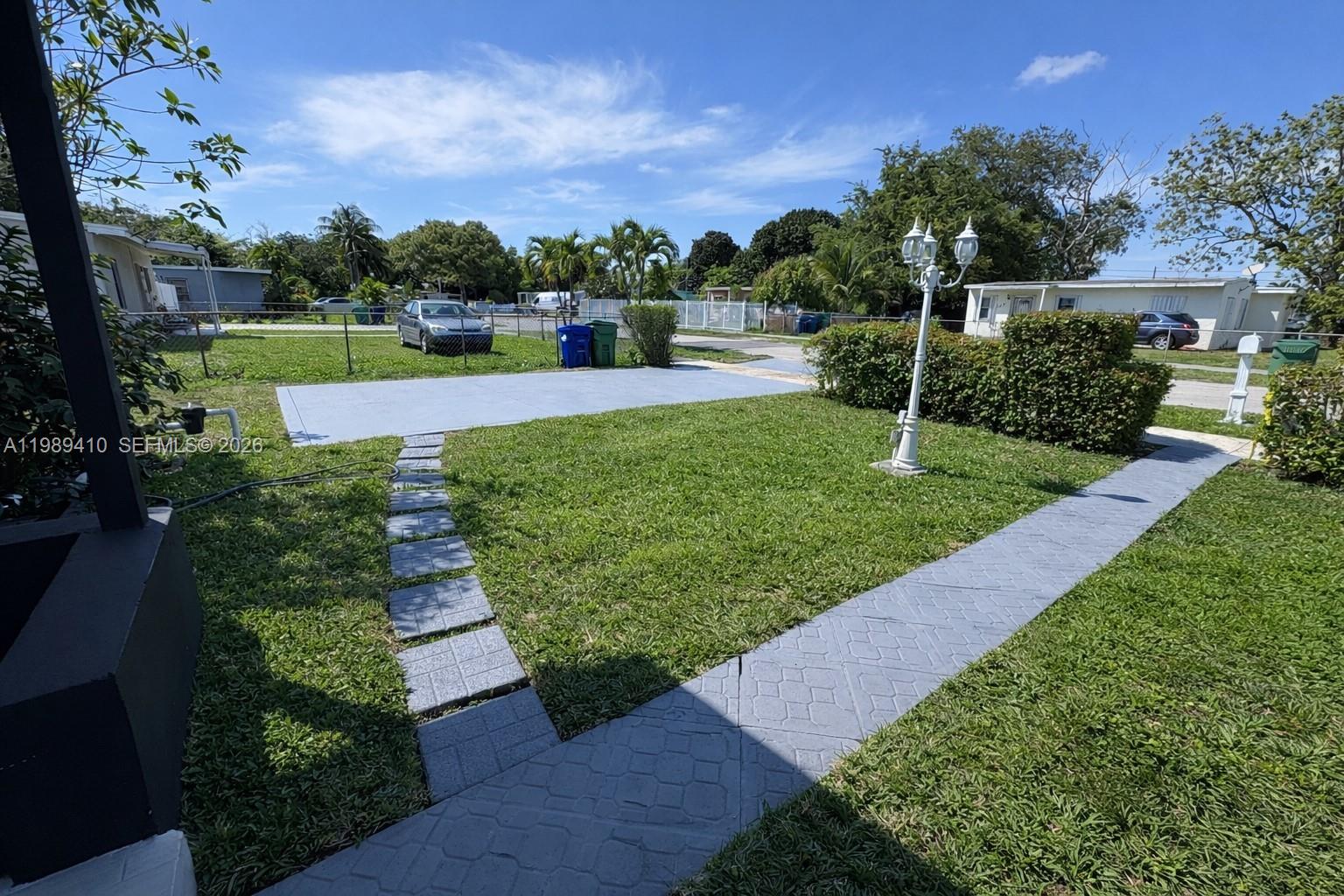 2450 Northwest 157th St Road Miami Gardens, FL 33054 - Photo 23 of 24 a view of a garden with a building in the background