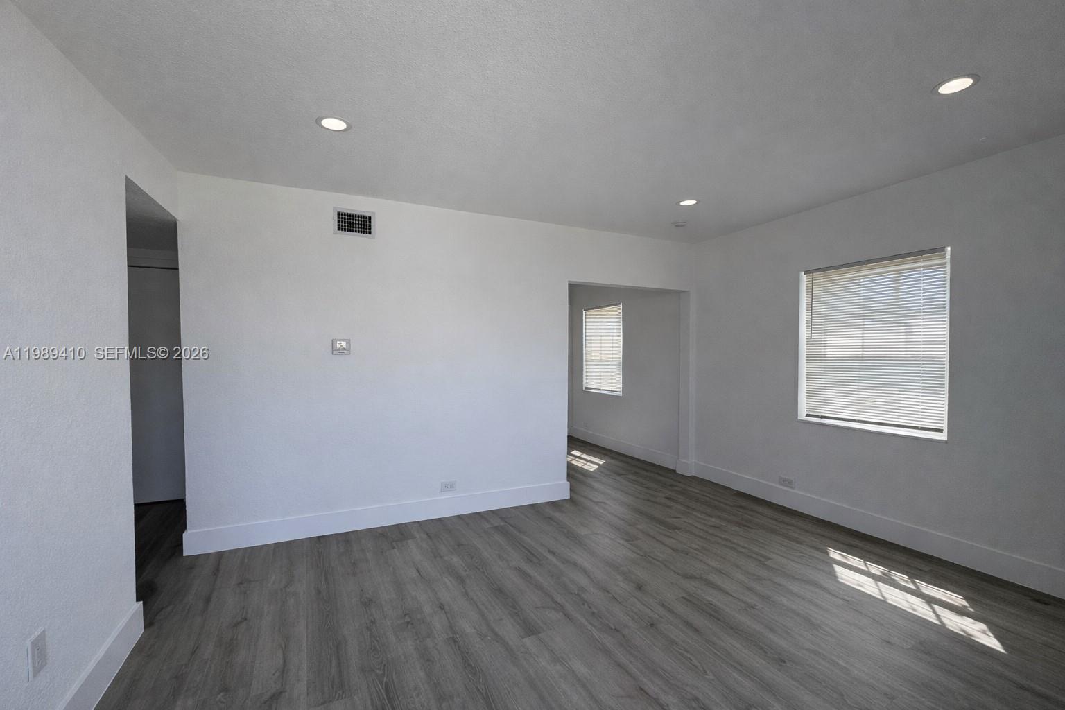 2450 Northwest 157th St Road Miami Gardens, FL 33054 - Photo 5 of 24 an empty room with wooden floor and windows