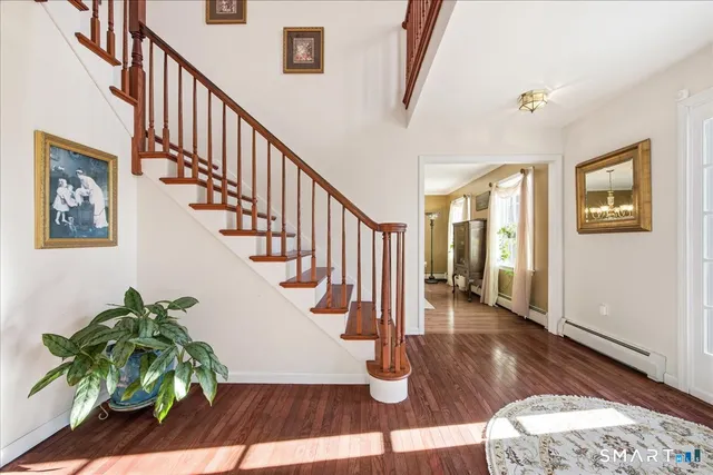 a view of entryway and hall with wooden floor