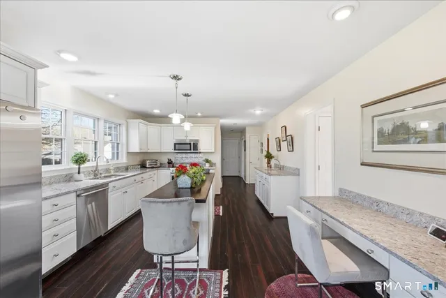 a kitchen with sink cabinets and wooden floor