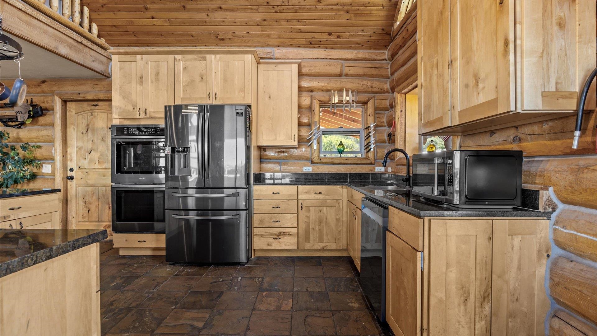 9291 54 Road Molina, CO 81646 - Photo 10 of 36 a kitchen with stainless steel appliances a refrigerator stove and microwave