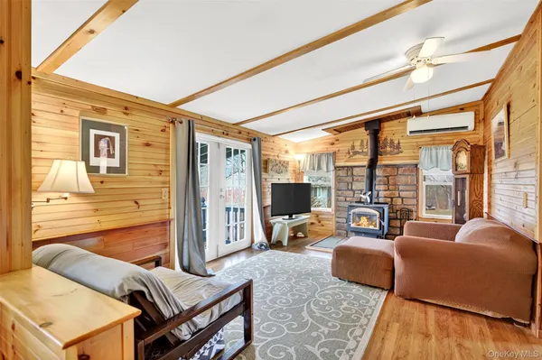 a living room with furniture and a floor to ceiling window