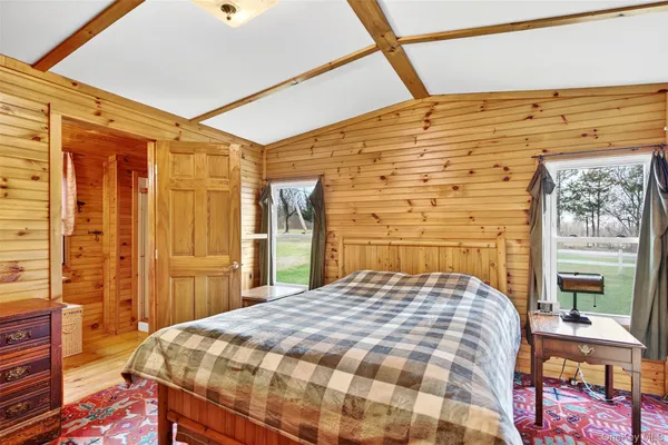 a bed sitting in a bedroom next to a window