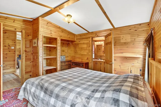 a bedroom with a bed and a flat tv screen