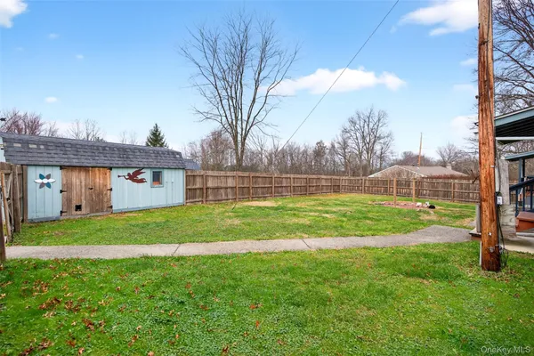a view of a house with a backyard