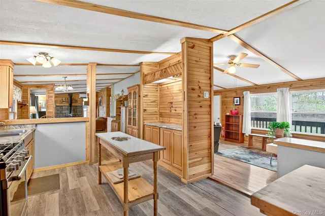 a view of a dining room with furniture large windows and wooden floor
