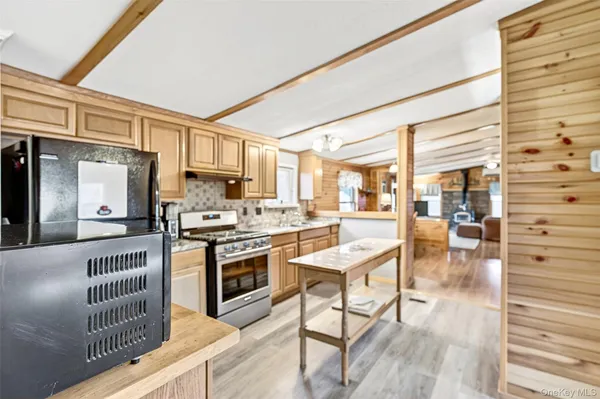 a kitchen with stainless steel appliances granite countertop a stove and cabinets