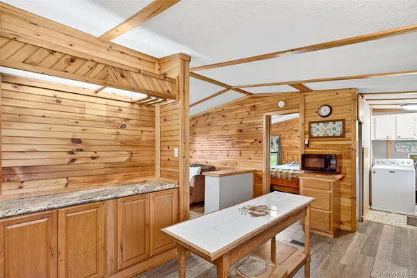 a view of a kitchen with stainless steel appliances granite countertop a stove and a refrigerator