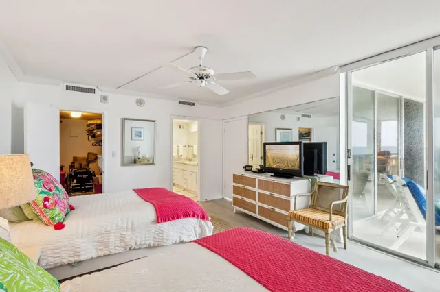 a bedroom with furniture and a flat screen tv