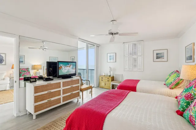 a bedroom with two bed and a flat screen tv