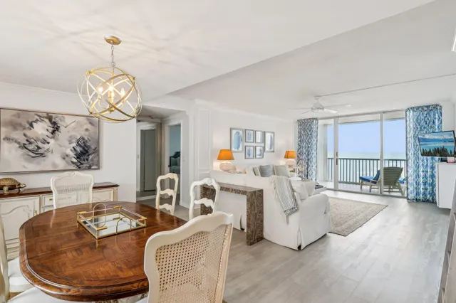 a living room with furniture a couch and a chandelier
