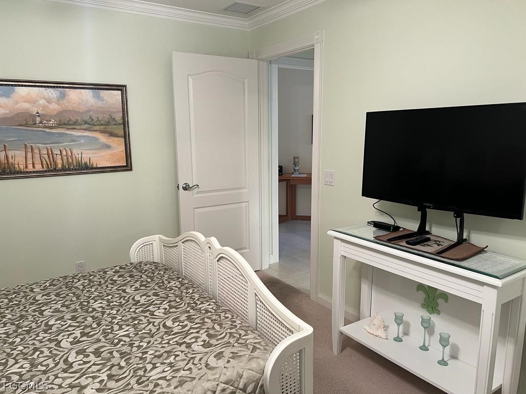 3013 Futuna Lane Naples, FL 34119 - Photo 11 of 21 a bedroom with a bed and a flat screen tv