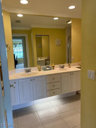 a bathroom with a sink vanity and mirror