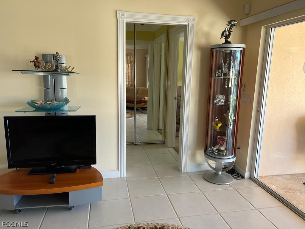 3013 Futuna Lane Naples, FL 34119 - Photo 19 of 21 a living room with furniture a flat screen tv and a fireplace