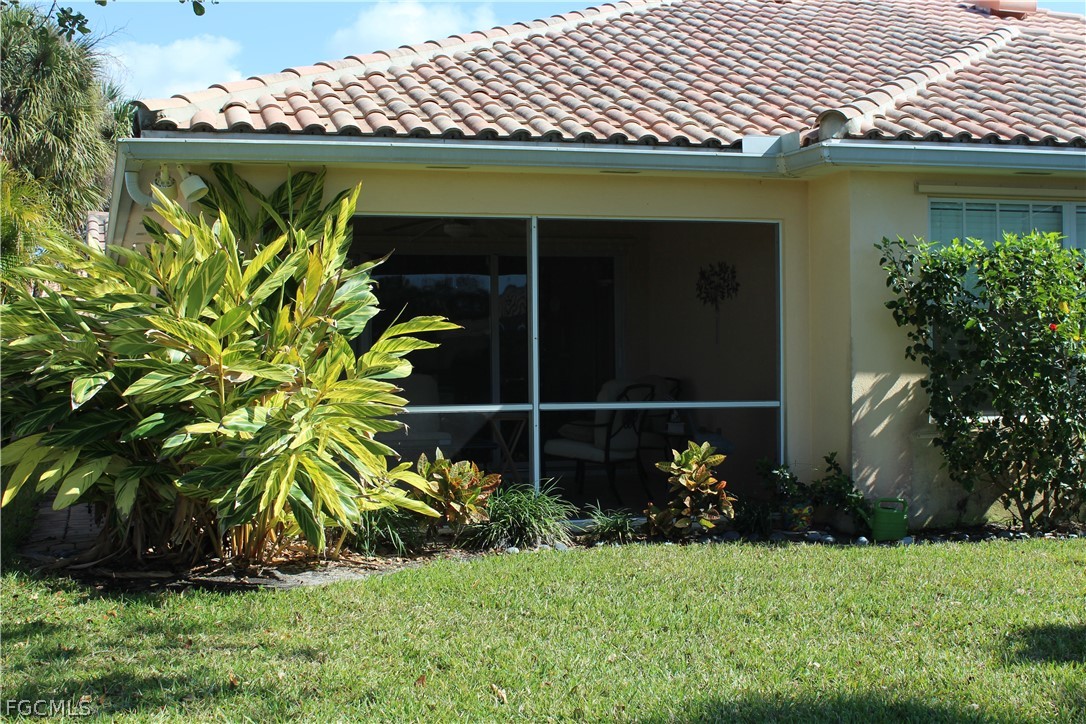 3013 Futuna Lane Naples, FL 34119 - Photo 2 of 21 a front view of a house with a yard